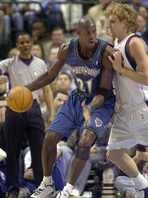 2003: Minnesota Timberwolves' Kevin Garnett drives against Dallas Mavericks' Dirk Nowitzki.