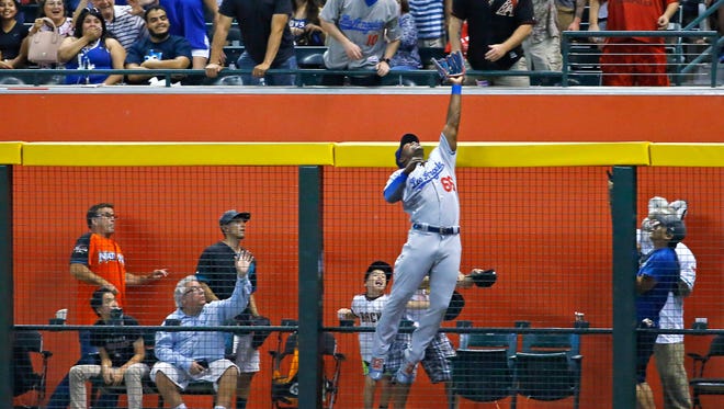 Aug. 8: Right fielder Yasiel Puig robs Diamondbacks' J.D. Martinez of a home run.