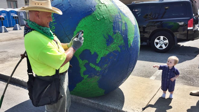 Erik Brendl walked from Hopkinsville to Louisville pushing a 6-foot-tall ball painted as a globe to get into the eclipse spirit. Aug. 20, 2017