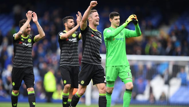 Chelsea's English defender Gary Cahill (2R) and teammates celebrate victory after the English Premier League football match between Everton and Chelsea at Goodison Park.