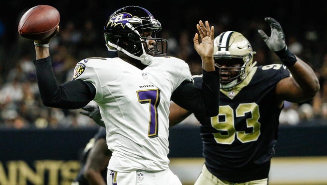 Baltimore Ravens quarterback Thaddeus Lewis (7) throws as New Orleans Saints defensive tackle David Onyemata (93) pressures  during the first half of a preseason game at the Mercedes-Benz Superdome.