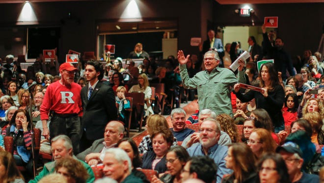 People react in agreement to a question posed to Rep. Leonard Lance, R-N.J., during a town hall meeting at Raritan Valley Community College on Feb. 22, 2017, in Branchburg, N.J.