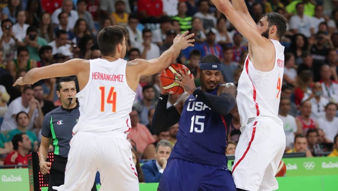 U.S. forward Carmelo Anthony (15) tries to pass out of a double-team by Spain defenders Guillermo Hernangomez Geuer (14) and Nikola Mirotic (44) during the men's basketball semifinals.