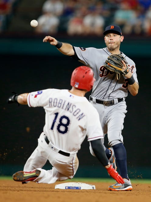 Tigers second baseman Ian Kinsler (3) attempts to turn a double play against Rangers centerfielder Drew Robinson (18) in the fourth inning on Monday, Aug. 14, 2017, in Arlington, Texas.
