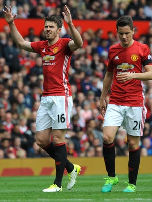 Manchester Uniteds Michael Carrick (L) and Manchester Uniteds Ander Herrera react during the English Premier League soccer match between Manchester United and Swansea City at Old Trafford stadium.
