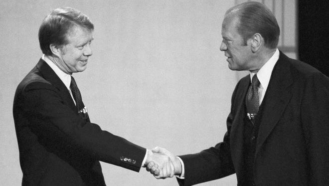 Carter and Ford shake hands before their debate at the Palace of Fine Arts Theatre on Oct. 6, 1976, in San Francisco.