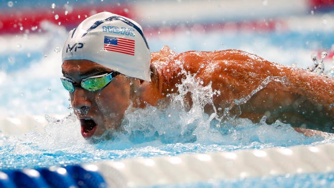 Michael Phelps swims during the men's 100 meter butterfly semifinal at the U.S. Olympic swimming team trials.
