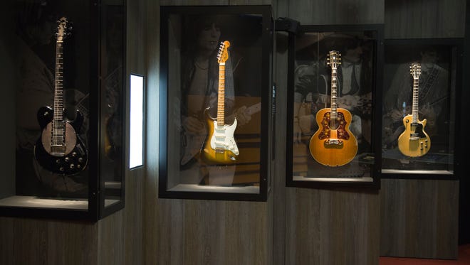 Decades of guitars owned by The Rolling Stones are displayed throughout the exhibit.