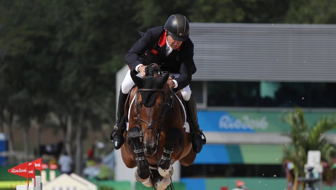 Nick Skelton of Great Britain rides Big Star to gold during the individual jumping equestrian final.
