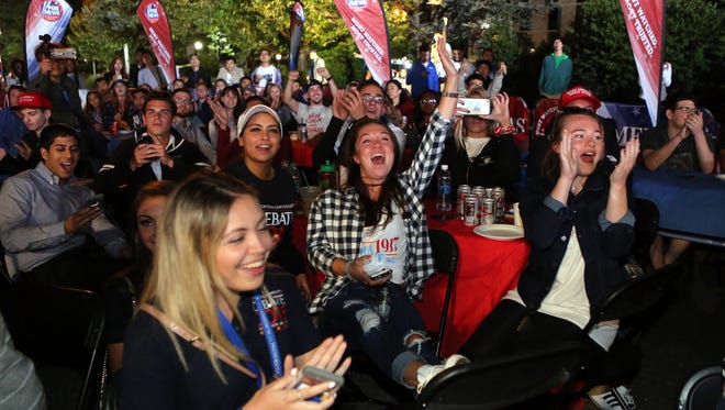 Students cheer at an outdoor debate watch party, as the first presidential debate gets underway on the Hofstra University campus.