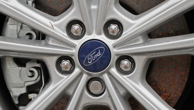 A Ford logo is seen on a wheel at a car store in London, Tuesday, Aug. 22, 2017.  Car manufacturer Ford is offering car buyers in Britain a 2,000-pound ($2,570) incentive to trade in older vehicles for new, less polluting models. (AP Photo/Frank Augstein)
