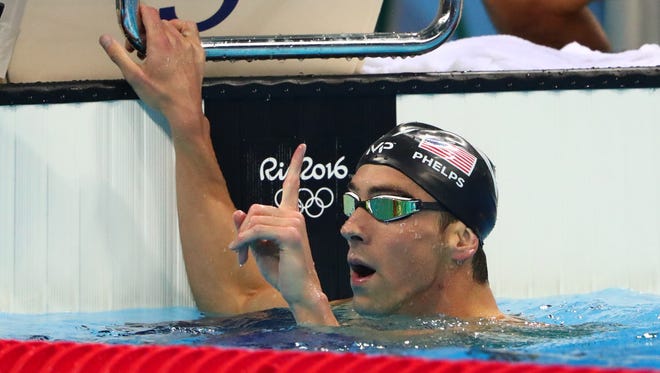 Michael Phelps celebrates after winning the men's 200-meter butterfly.