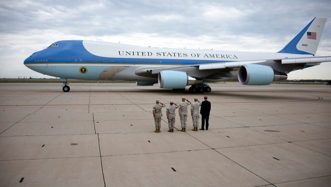 Marines salute as President Obama leaves in Air Force One from Marine Corps Air Station Miramar in San Diego Oct. 12, 2015.