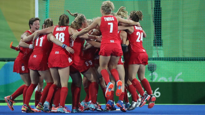 Great Britain defender Hollie Webb (20) celebrates with teammates after scoring the game winning goal in a shoot out past Netherlands goalkeeper Joyce Sombroek during the gold medal match in the Rio 2016 Summer Olympic Games at Olympic Hockey Centre.