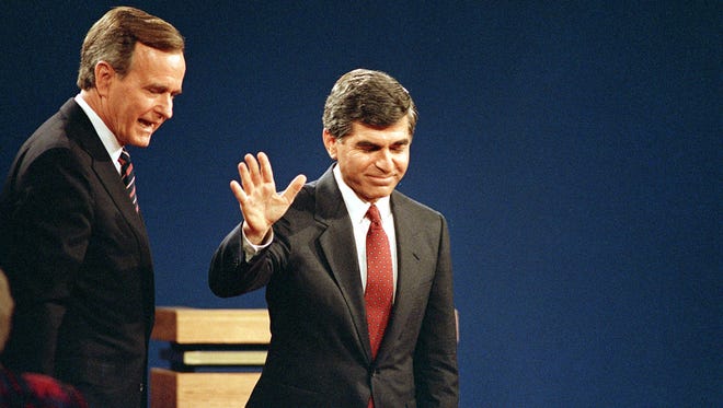 Dukakis acknowledges the audience as Bush looks on after their final debate in Los Angeles on Oct. 13, 1988.