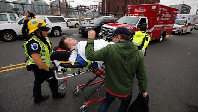 A person is taken on a stretcher after a N.J. Transit train crashed in to the platform at the Hoboken Terminal.