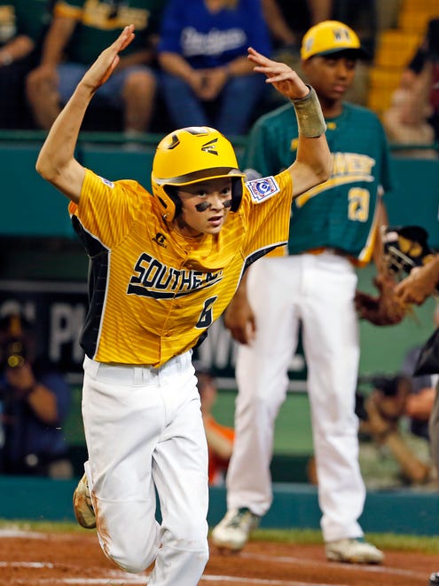 Greenville, N.C.'s Chase Anderson (6) celebrates after scoring on a wild pitch against South Dakota.