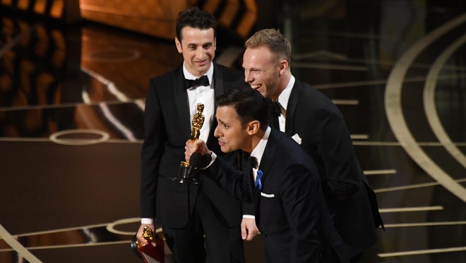 Justin Hurwitz, left,  Benj Pasek and Justin Paul, right, accept  the award for Best Original song for 'City Of Stars' from 'La La Land' during the 89th Academy Awards.