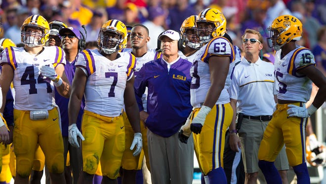 LSU coach Les Miles (center) and his players didn't like what they saw on the scoreboard in the fourth quarter Saturday.