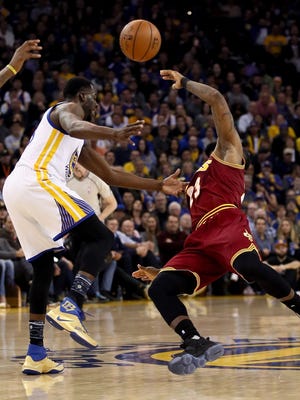 Draymond Green of the Golden State Warriors fouls LeBron James of the Cleveland Cavaliers at Oracle Arena on January 16, 2017 in Oakland, California.