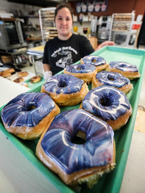 Brandi Donovan, with Whistle Stop Donuts in Hopkinsville, shows off Galaxy doughnuts that are being produced for the solar eclipse.
August 20, 2017