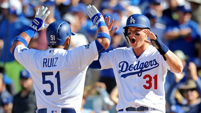 NLDS, Game 3: Carlos Ruiz celebrates with Joc Pederson after hitting a pinch hit two run home run in the fifth inning to cut the Nationals lead to 4-3.