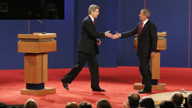 Kerry and Bush shake hands at their debate on Oct. 13, 2004, in Tempe, Ariz.