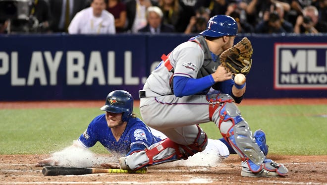 ALDS, Game 3: Blue Jays' Josh Donaldson scores the winning run past catcher Jonathan Lucroy in the 10th inning to sweep the Rangers.