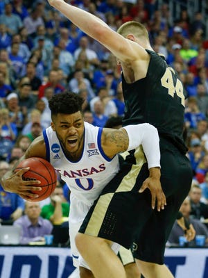 Kansas Jayhawks guard Frank Mason III (0) collides with Purdue Boilermakers center Isaac Haas (44) during the first half in the semifinals of the midwest Regional of the 2017 NCAA Tournament at Sprint Center.