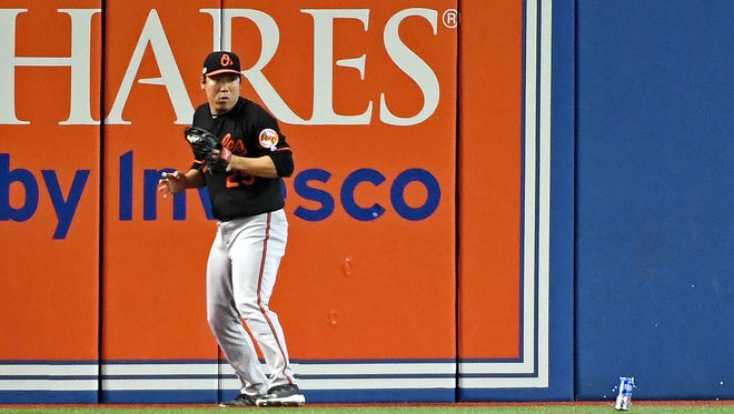 AL wild-card game: Orioles left fielder Hyun Soo Kim was nearly hit in the head by a beer can while making a catch on a fly ball near the wall in the seventh inning.
