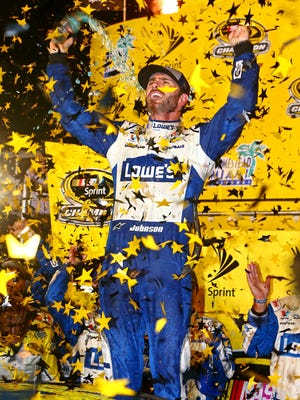 NASCAR Sprint Cup Series driver Jimmie Johnson (48) celebrates winning the NASCAR Sprint Cup championship after the Ford Ecoboost 400 at Homestead-Miami Speedway.