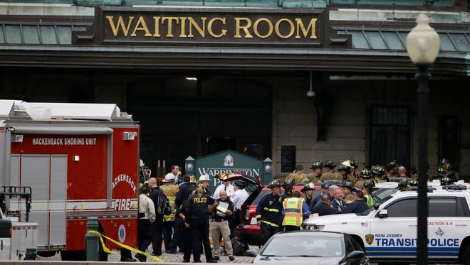 Emergency officials stand outside of the Hoboken Terminal following a train crash Sept. 29, 2016 in Hoboken, N.J. A commuter train crashed into the rail station during the morning rush hour, causing serious damage.