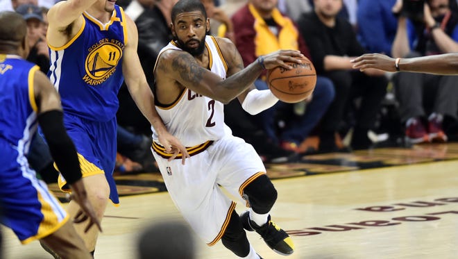 Cleveland Cavaliers guard Kyrie Irving (2) drives to the basket against Golden State Warriors guard Klay Thompson (11) during the fourth quarter in game three of the 2017 NBA Finals at Quicken Loans Arena.