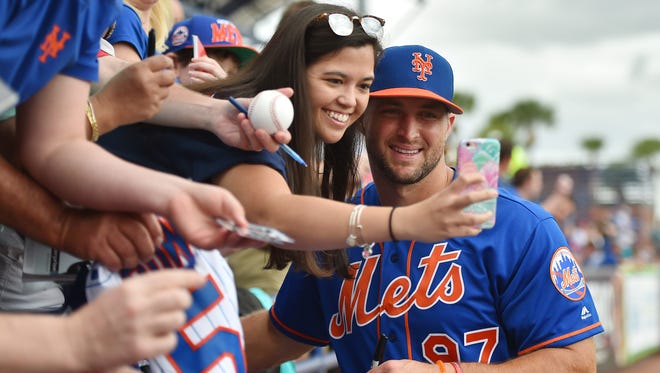 March 8: Tim Tebow  takes a selfie picture with a fan prior to the game.
