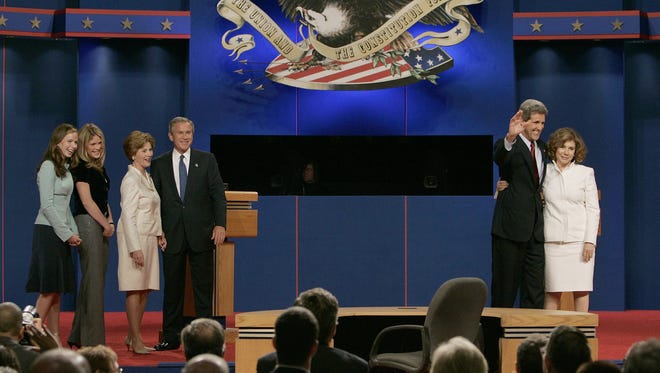 From left: Barbara Bush, Jenna Bush, first lady Laura Bush, George W. Bush, John Kerry and Theresa Heinz-Kerry share the podium to thank the audience at the conclusion of the first Bush-Kerry first debate at the University of Miami on Sept. 30, 2004.