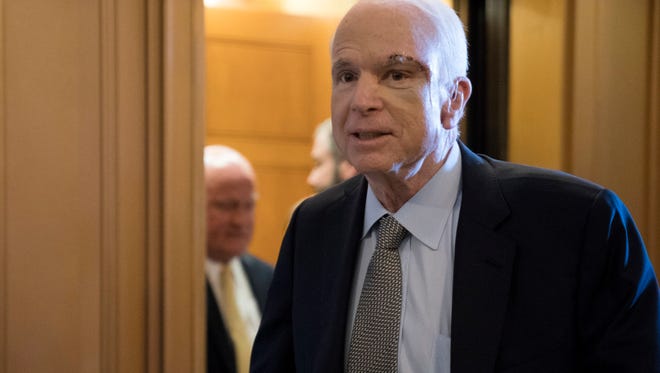 Sen. John McCain, R-Ariz., walks to the Senate floor to vote in favor of a motion to proceed on the effort to repeal and replace Obamacare on July 25, 2017, less than a week after he was diagnosed with brain cancer.