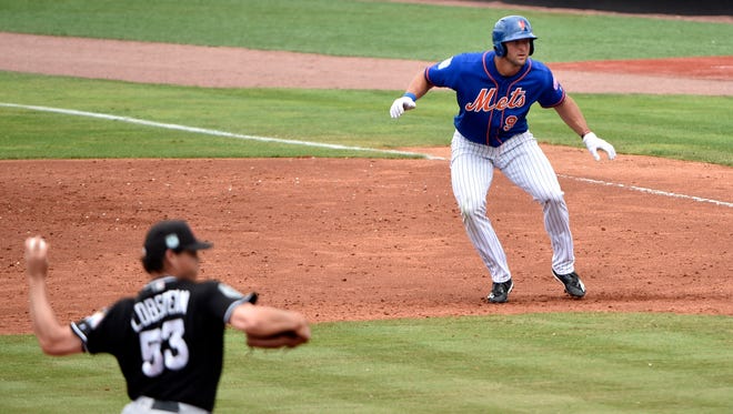 March 13: Tim Tebow (97) leads off of first base against the Marlins.