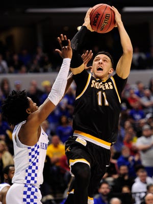 Wichita State Shockers guard Landry Shamet (11) shoots against Kentucky Wildcats guard De'Aaron Fox (0) during the second half in the second round of the 2017 NCAA Tournament at Bankers Life Fieldhouse.