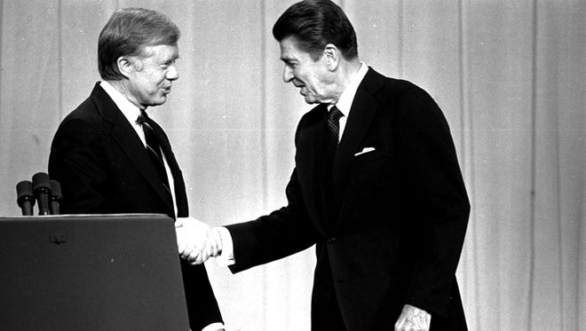 Carter and Reagan shake hands before their debate on Oct. 28, 1980, in Cleveland.