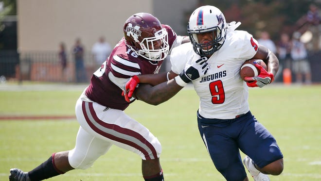 Mississippi State defensive lineman Johnathan Calvin, tries to tackle South Alabama running back Tyreis Thomas (9) in the first half of an NCAA college football game in Starkville, Miss., Saturday, Sept. 3, 2016. (AP Photo/Rogelio V. Solis)