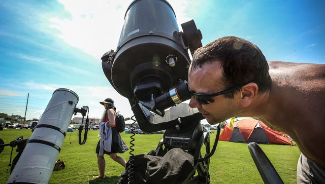 Brian Badgett of Louisville checks out one of his two telescopes in a soccer field transformed into a campground on Sunday afternoon.
August 20, 2017