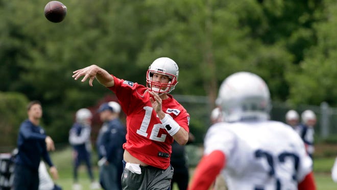 New England Patriots quarterback Tom Brady throws to Dion Lewis  during practice.