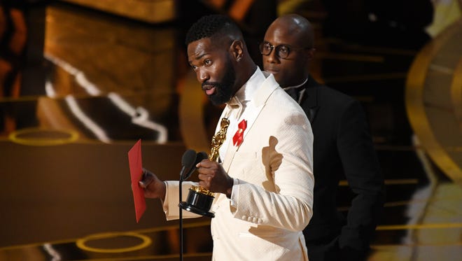 Tarell Alvin McCraney, left, and Barry Jenkins accept the award for best Adapted screenplay for 'Moonlight' during the 89th Academy Awards.