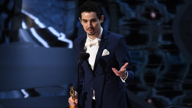 Damien Chazelle accepts the Oscar for Best Director for 'La La Land' during the 89th Academy Awards.