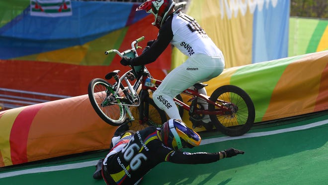 David Graf of Switzerland, top, crashes into Zabala Oquendo of Colombia during the men's BMX final.