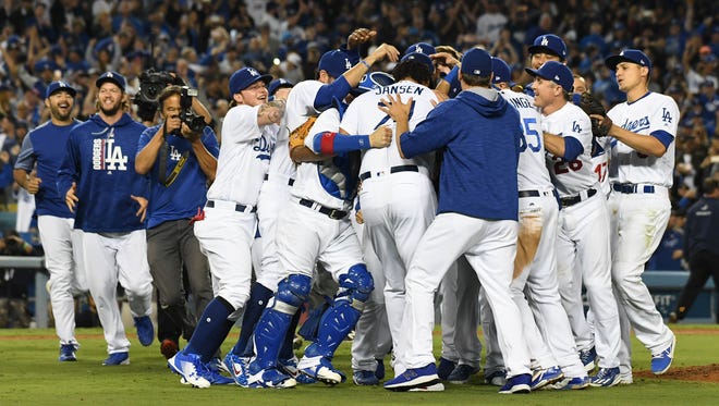 Sept. 22: The Dodgers celebrate after clinching their fifth straight NL West title.