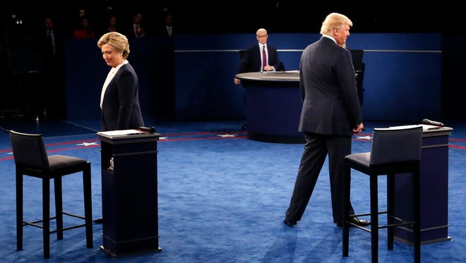 Clinton and Trump arrive on stage during the second presidential debate at Washington University in St. Louis on Oct. 9, 2016.