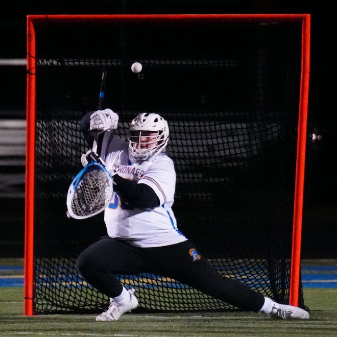 Mukwonago goalie Evan Ban (30) blocks a shot during the lacrosse match at home against Homestead on Tuesday, March 19, 2024. Homestead won 11-10.