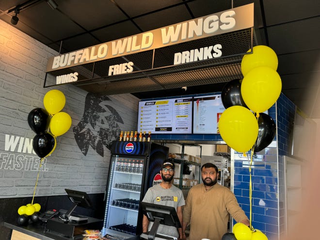 Sai Mulumudi, store manager, and Hemanagu Koneru, Kardo Group director of operations, stand behind the counter inside Buffalo Wild Wings GO in Waukesha. The 2,400-square-foot restaurant, 2720 N. Grandview Blvd., Suite 130, opened March 20 in the strip mall built on the site of Weissgerber's Gasthaus restaurant off Silvernail Road.