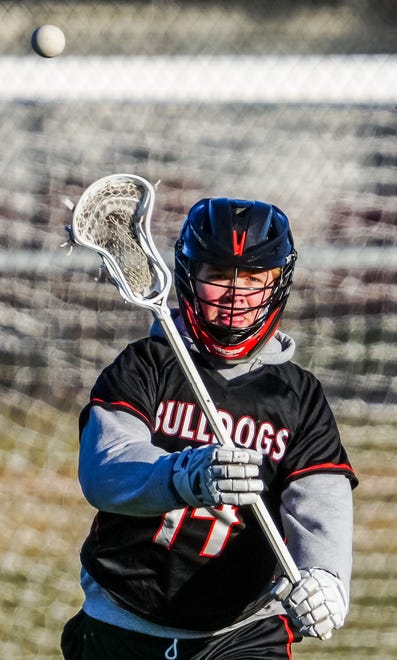 Cedarburg's Connor Plunk (14) makes a pass during the lacrosse match at Catholic Memorial on Wednesday, March 20, 2024.